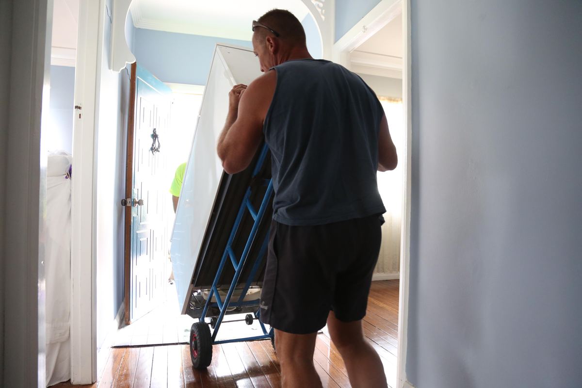 Appliance being moved out of a home on a dolly